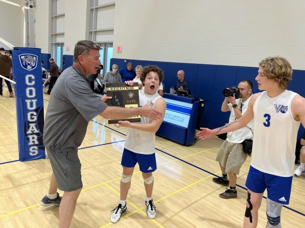 Brian McDonald awards the 2022 boys’ volleyball team the Regional trophy.