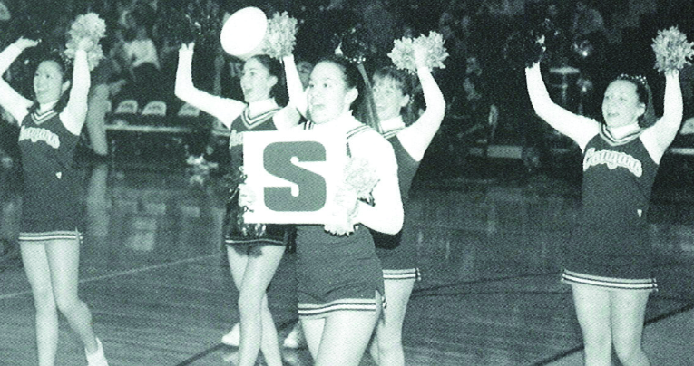 2001 VHHS cheerleaders dance to YMCA while spelling out VHHS with poster letters.