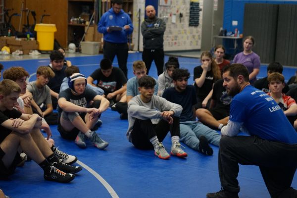 Coach Wolter gives both wrestling teams a pep talk about future practices and matches