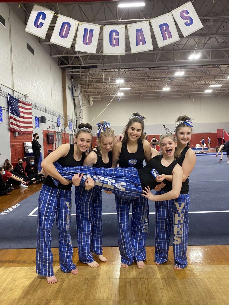 Mia Bellini is lifted by members of the
gymnastics team her freshman year. 