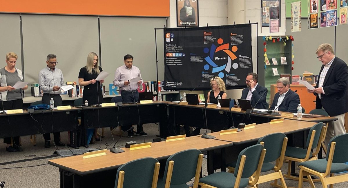 The new board members, (left to right) Austin, Deshmukh, Polen, Kotwal and Fleegle taking their Oath of Office at the April 28 school board meeting.
