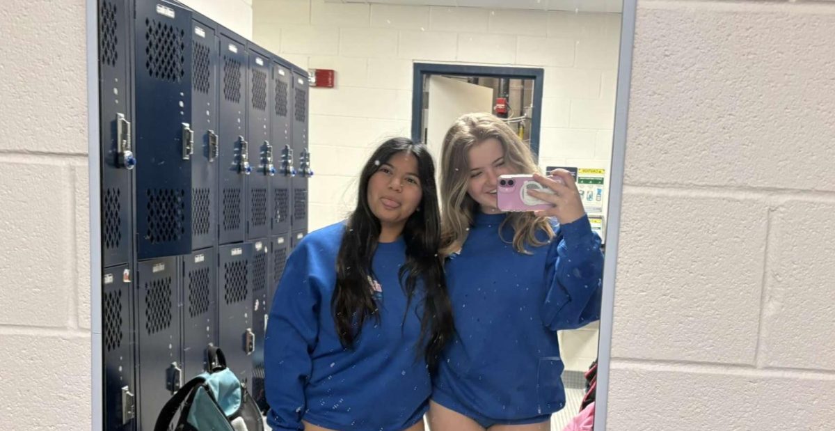 Sophie Farooqui (9) takes a photo with Violet Bossler (12) before practice.