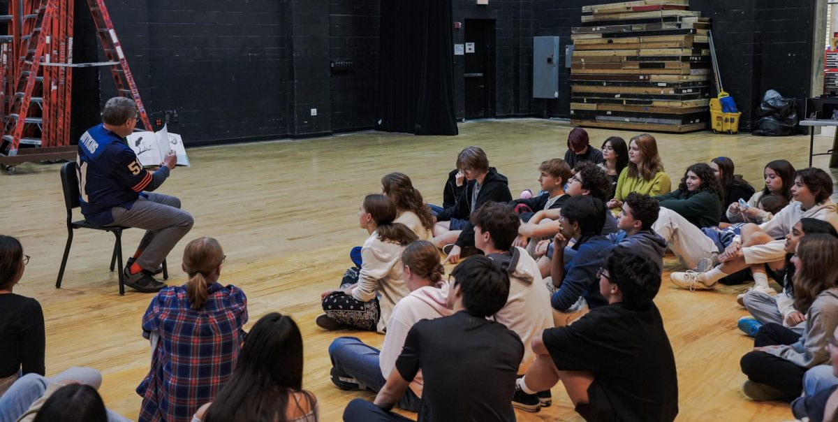 Kevin Phelan reads Yurtle the Turtle by Dr.
Seuss to the cast before rehearsal. | AJ Kneir